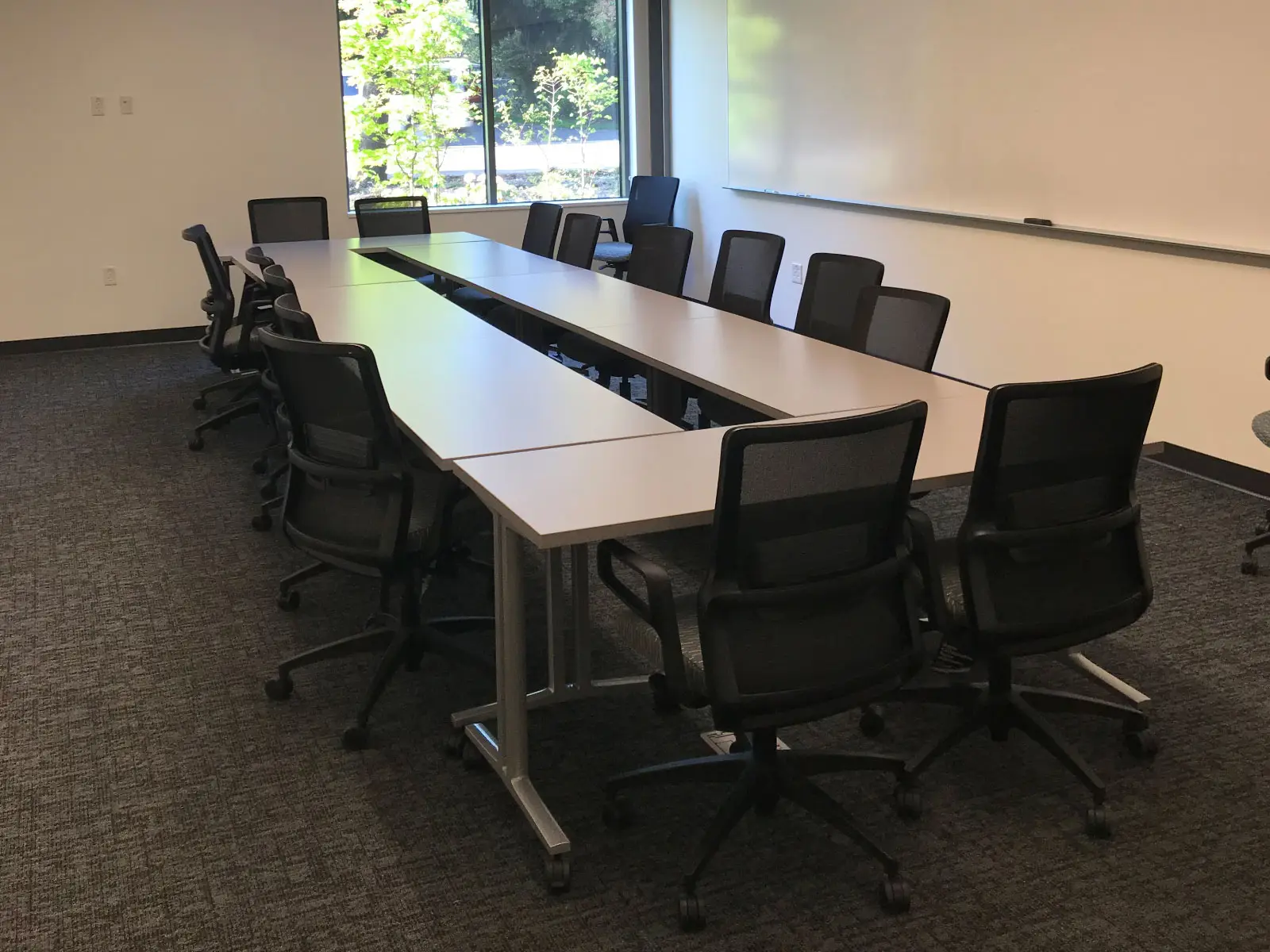A long meeting table with many chairs in a Harmony campus conference room A long meeting table with many chairs in a Harmony campus conference room