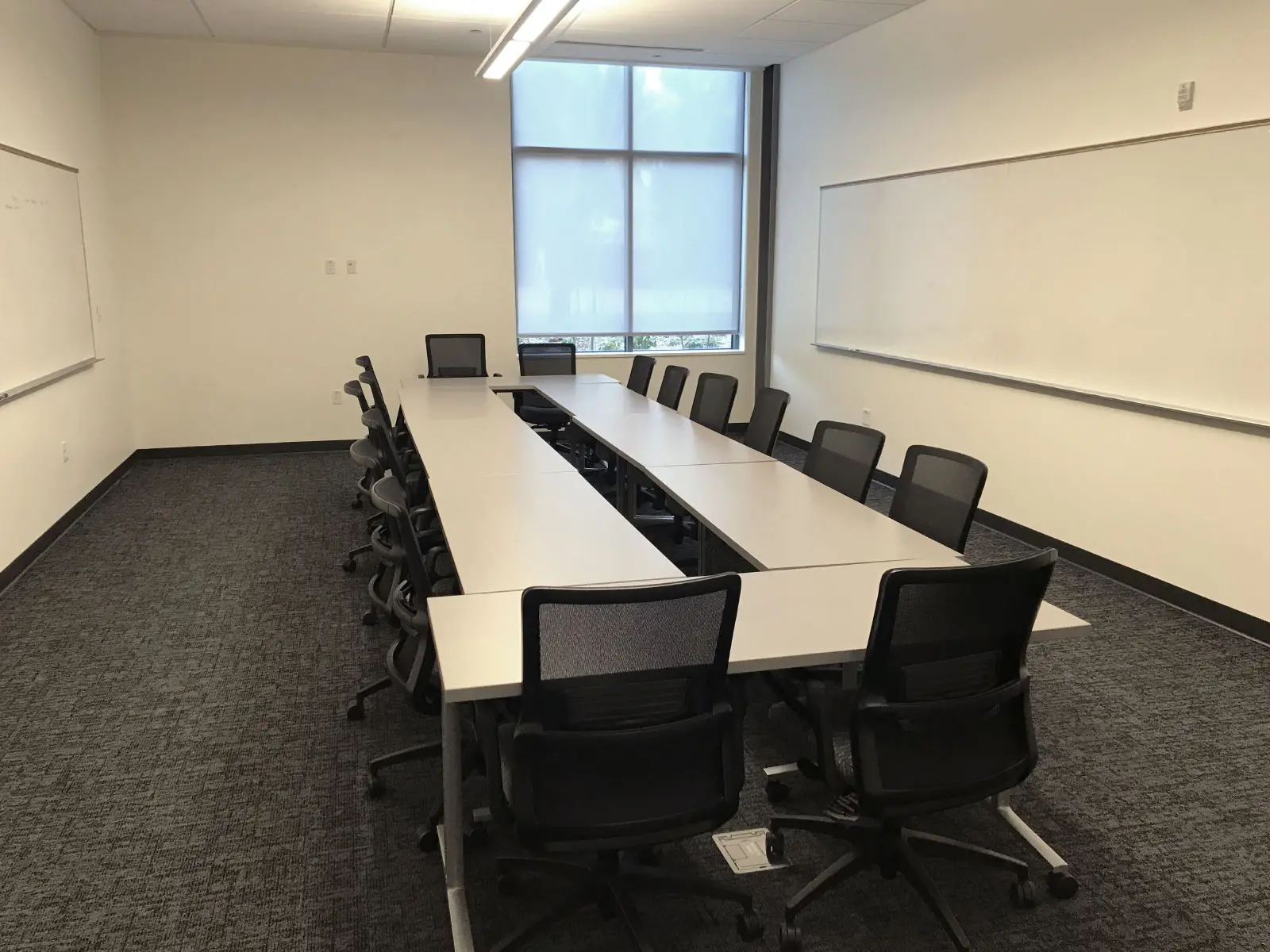 Two rows of chairs and tables in a large Harmony campus conference room Two rows of chairs and tables in a large Harmony campus conference room