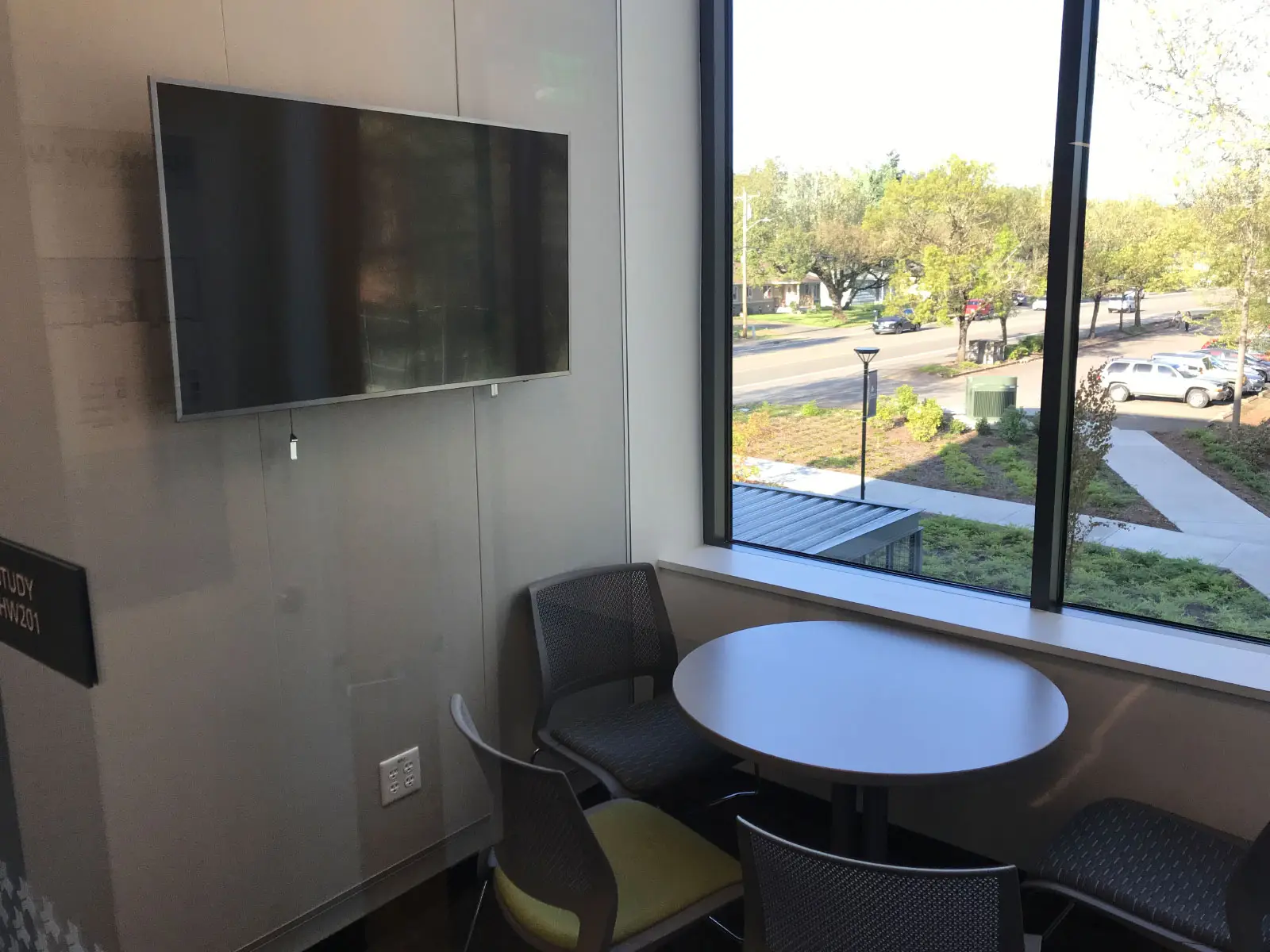 A TV screen in front of a window and small table with chairs in the Harmony campus conference room A TV screen in front of a window and small table with chairs in the Harmony campus conference room