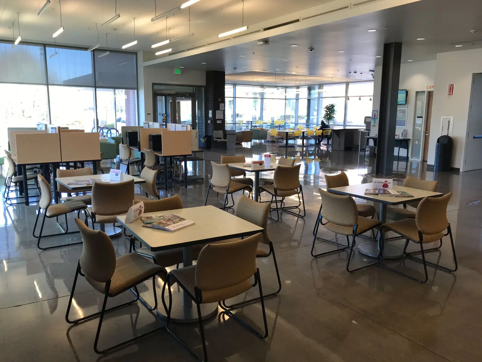Series of chairs and small tables in Harmony Campus lobby Series of chairs and small tables in Harmony Campus lobby