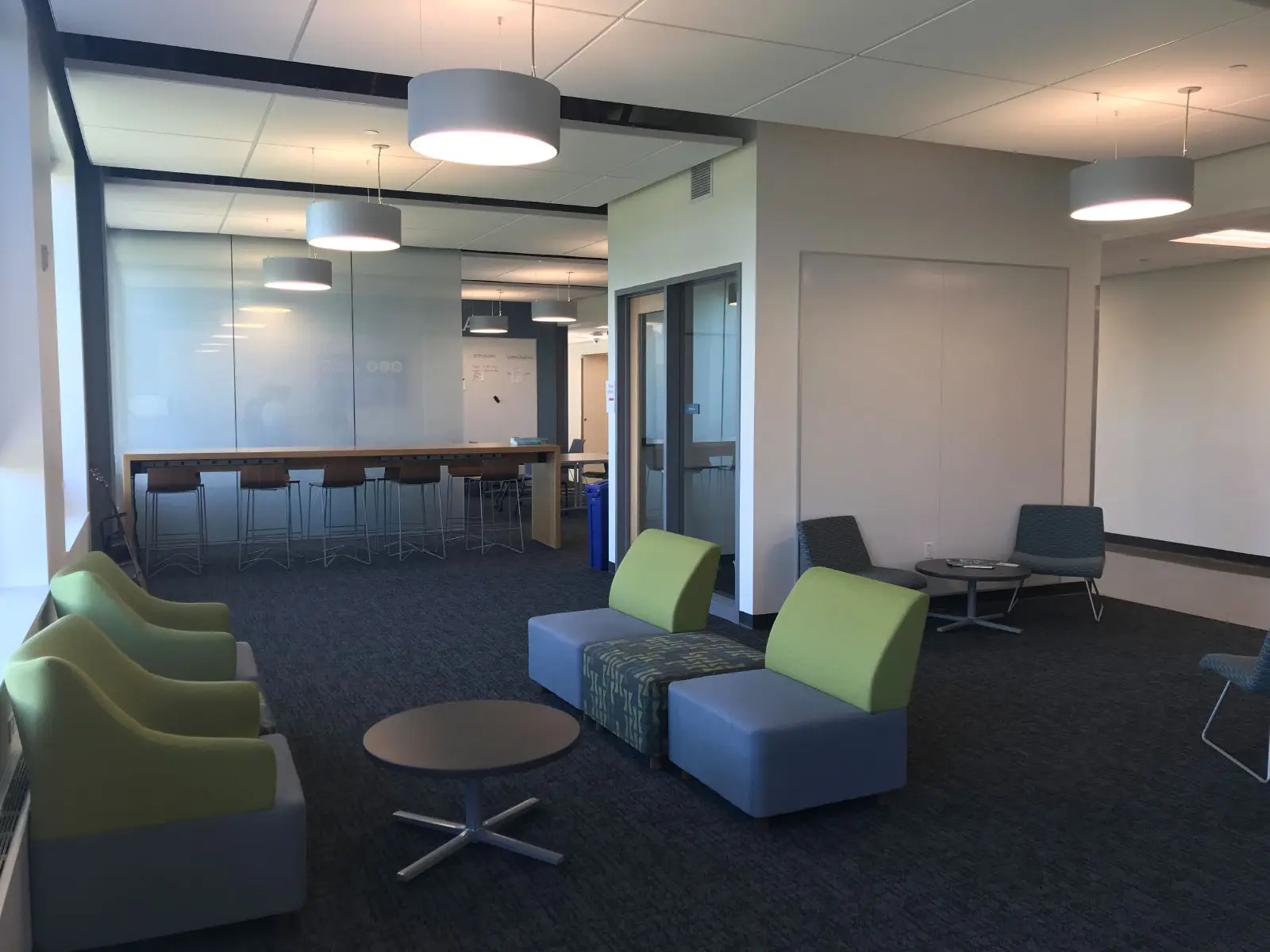 Various small meeting spaces with green and blue chairs in the Harmony campus lobby Various small meeting spaces with green and blue chairs in the Harmony campus lobby