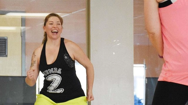 woman exercises wearing shirt that says