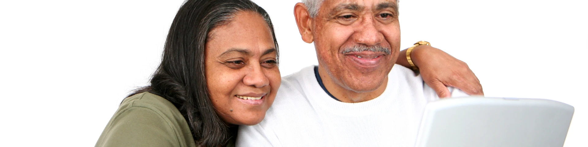Two people smiling while looking at a laptop screen