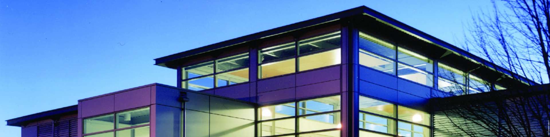 Exterior of Wilsonville campus building lit from the inside at twilight