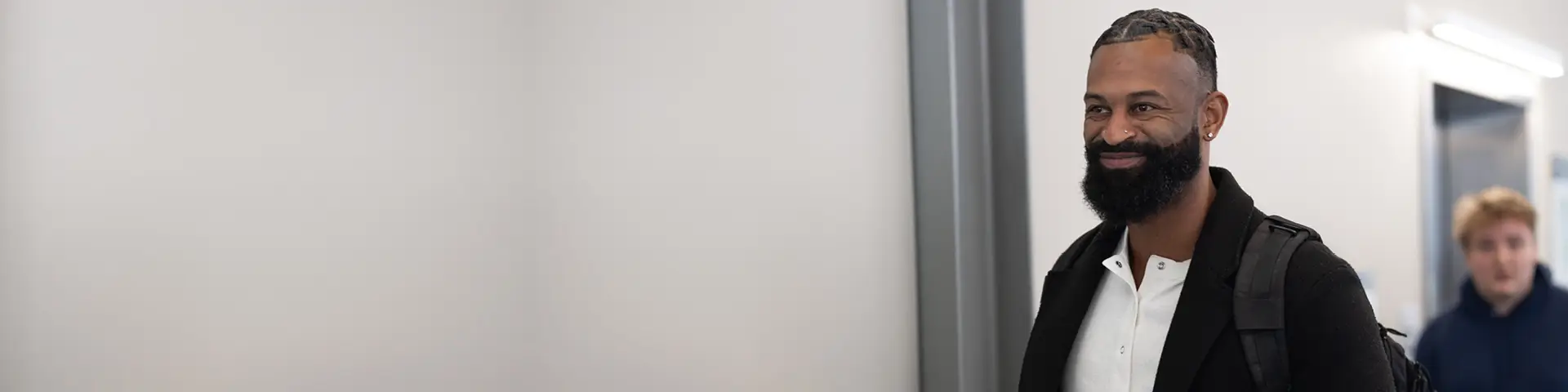 Two community members walking in a hallway on CCC's campus