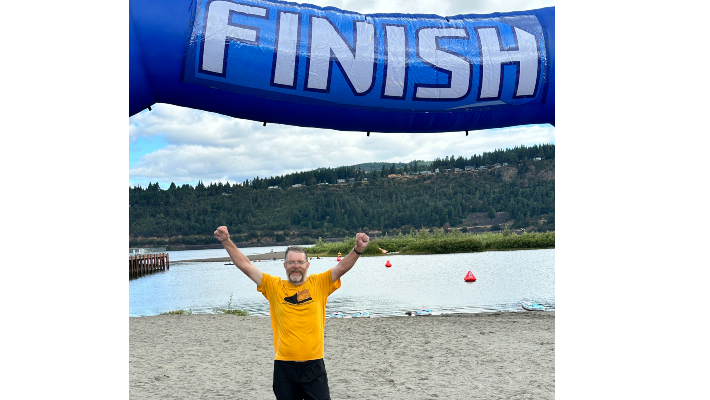 CCC President Tim Cook raises his arms in celebration at the ROCCS finish line