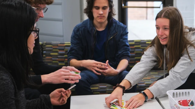 CCC students play the card game Uno at the Wacheno Welcome Center on the Oregon City campus