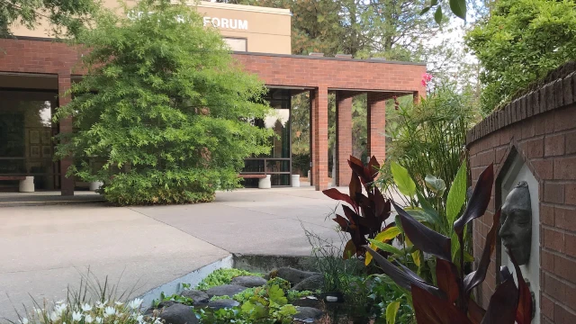 Exterior of Gregory Forum on CCC's Oregon City campus with a fountain and landscaping in the foreground